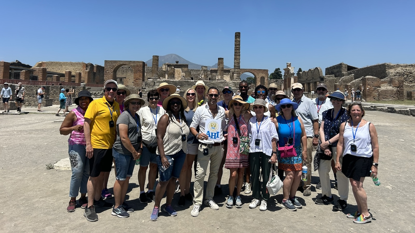 TU alumni pose for a photo in front of ancient ruins