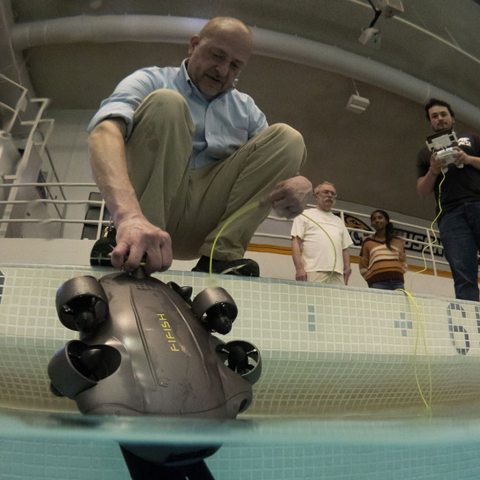 Richard Seigel and students test an underwater drone