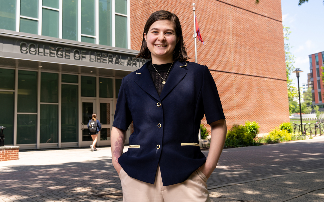 Ashley Hajimirsadeghi standing in front of the College of Liberal Arts