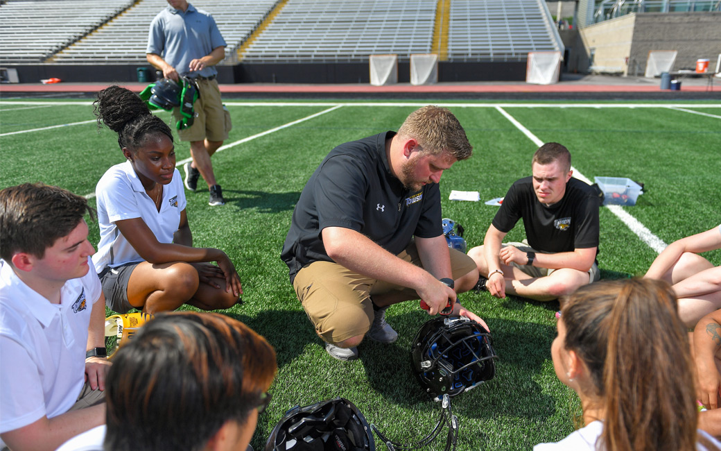 Athletic training students watch a demonstration