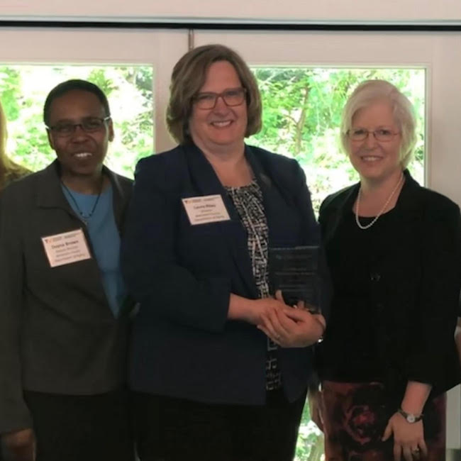 Three women with an award