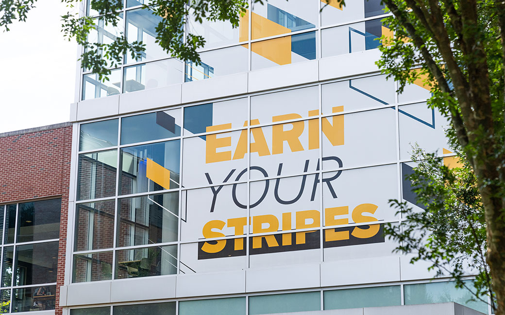 Side of building that says Earn Your Stripes