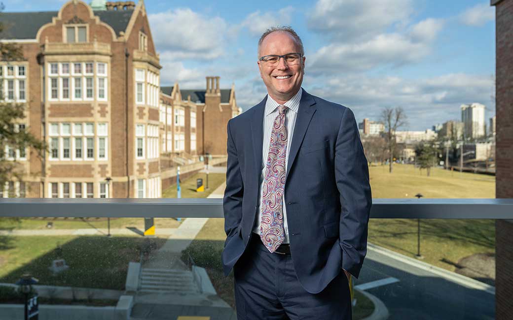 Boyd Bradshaw portrait in front of campus