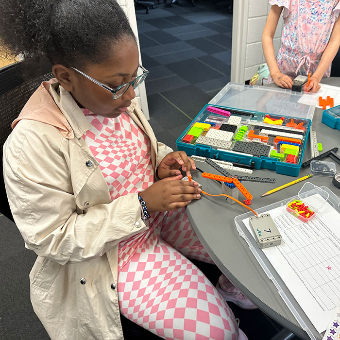 Girl building robots