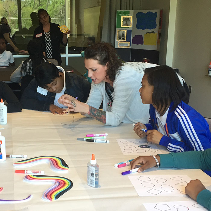 Students at table with teacher