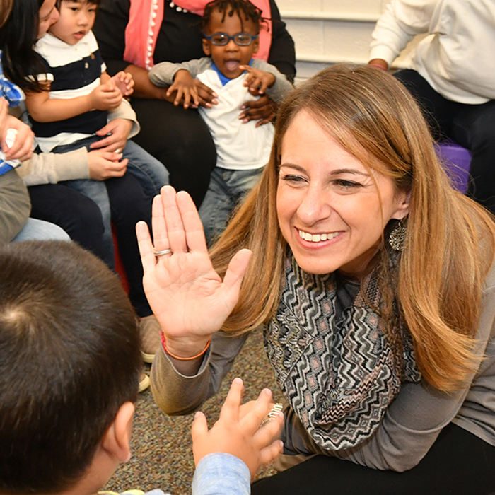 Staff highfiving student