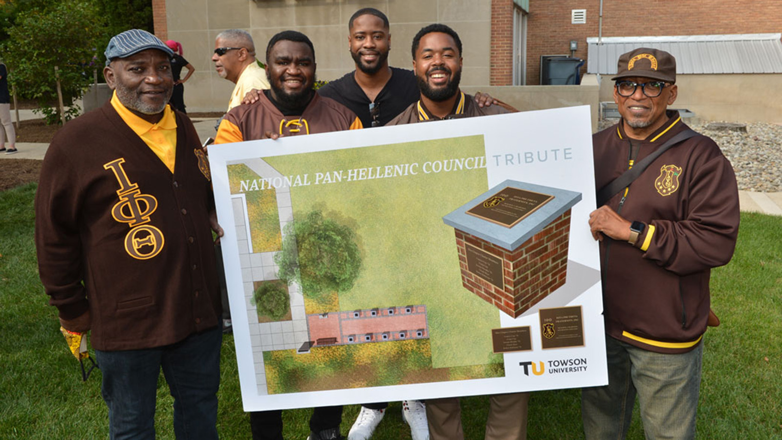 Members of the Iota Phi Theta hold up a rendering of the National Pan-Hellenic Council Tribute