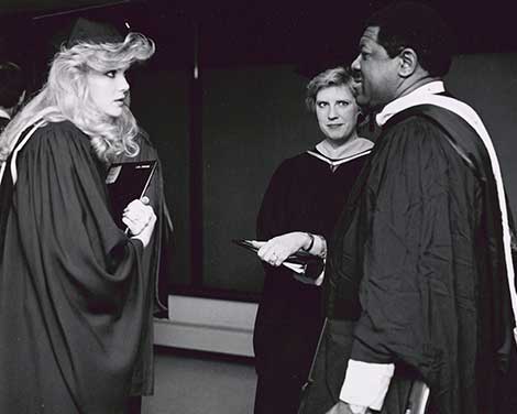 A student and several staff members in 1986 at Commencement