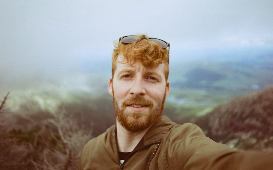 Man selfie with valley in background