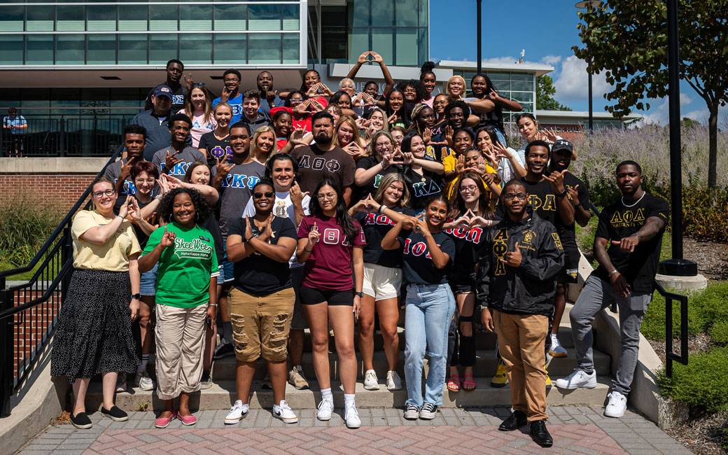 Greek life members gather for a group photo on Burdick steps