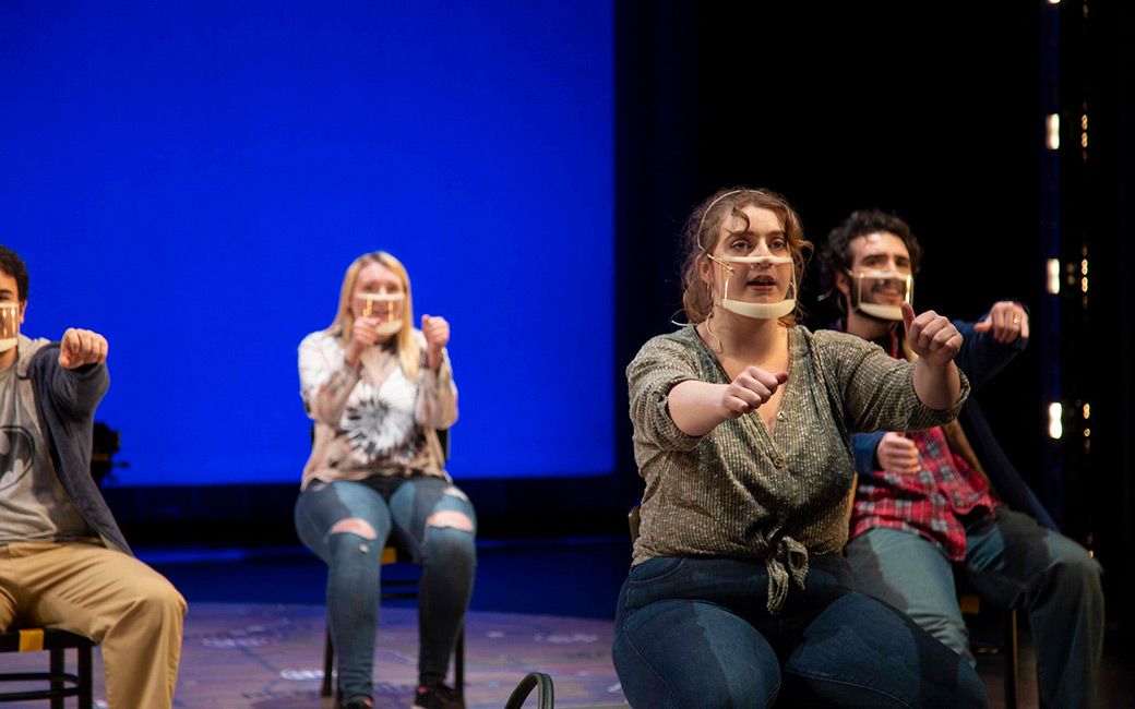 Students in masks acting