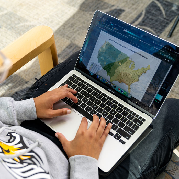 Image of student using laptop to look at rainfall map