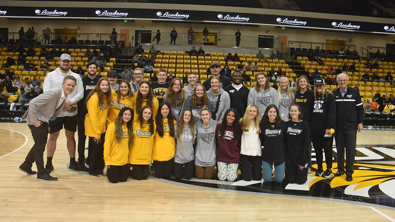 President Ginsberg poses with the women's volleyball team