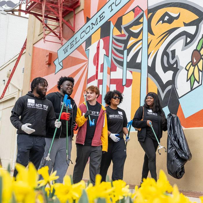 Student volunteers clean up uptown Towson during Impact TU