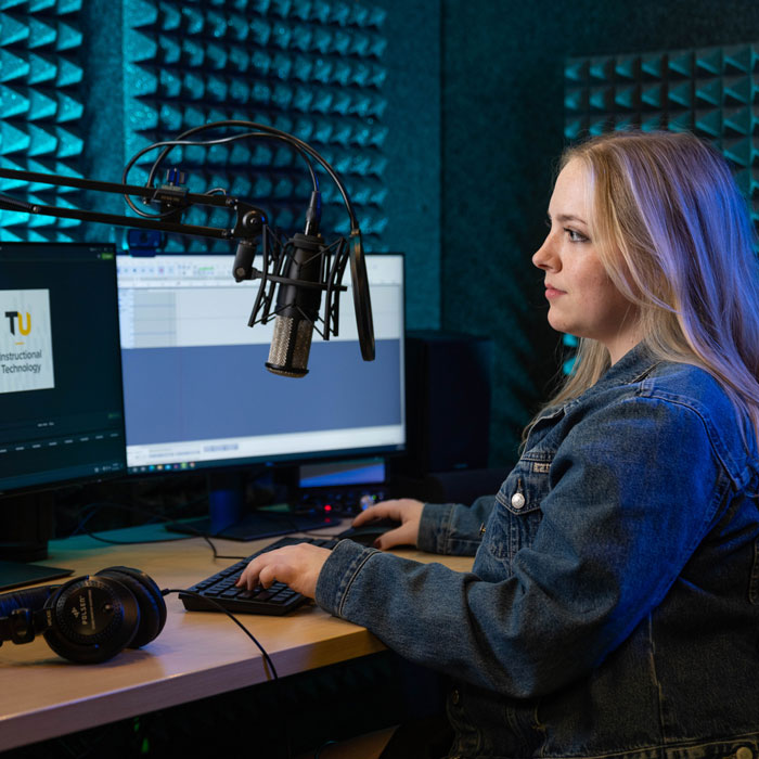 Student sits in soundbooth