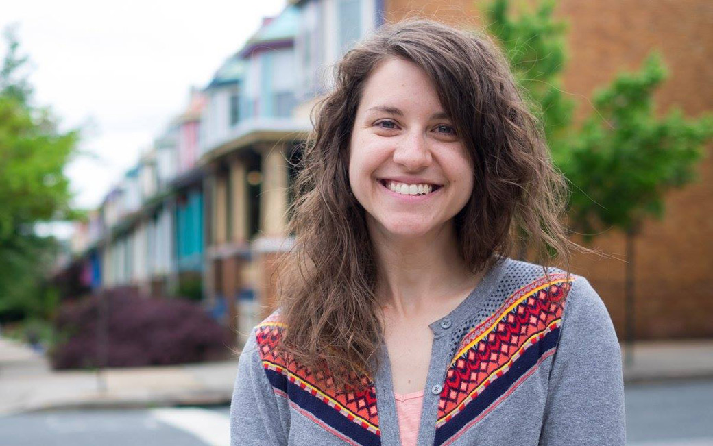 Woman portrait with rowhouses in background