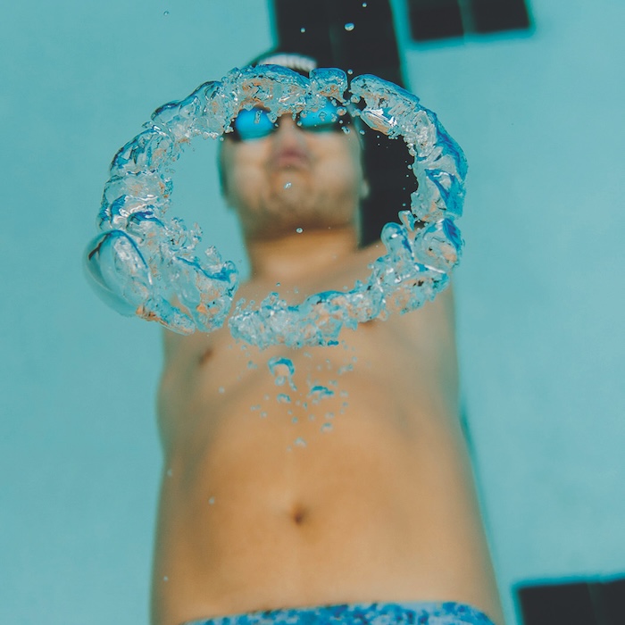 Marty Hendrick swimming underwater and blowing a bubble ring