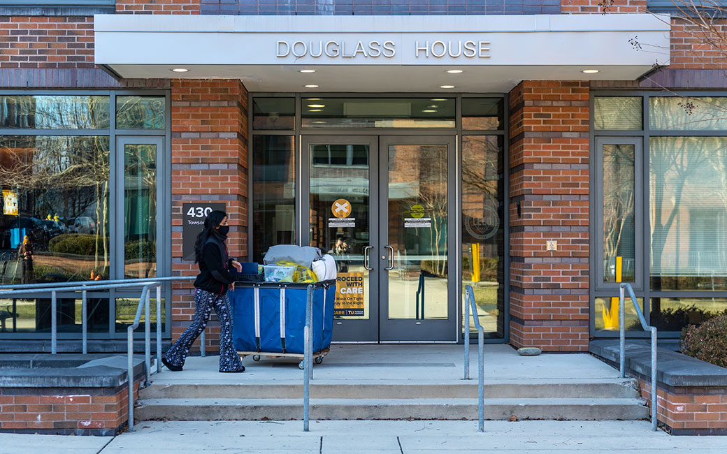 Student with moving cart at doorway