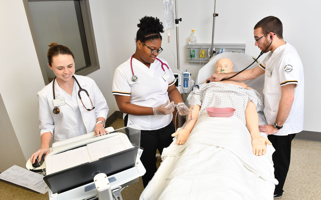 TU nursing students work on a  Bluetooth-enabled advanced life support mannequin that is hooked up to a computer that gives feedback about nursing students’ performance during simulations.