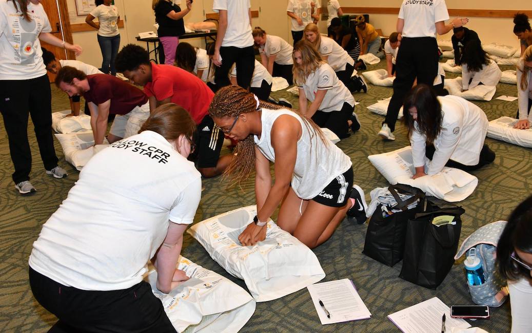 Students practicing pillow CPR