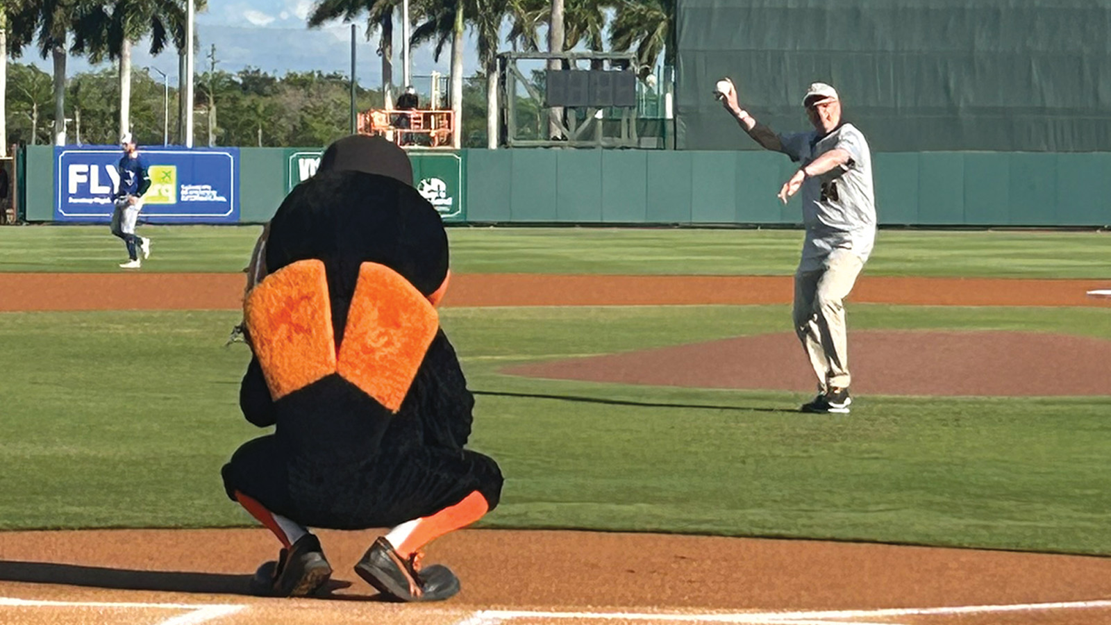 president ginsberg throwing out the first pitch during an O’s spring training game in Florida