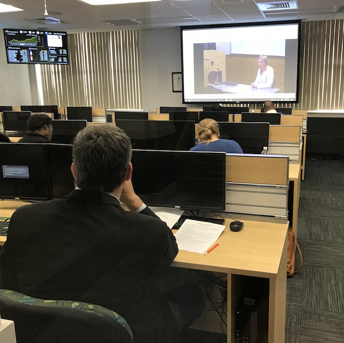 Sales professionals judged students' pitches via a closed-circuit video feed.