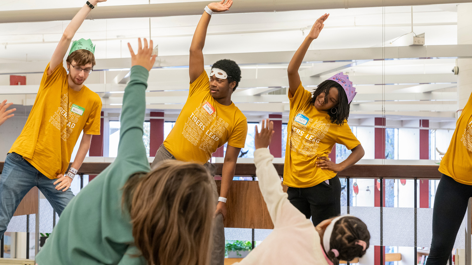 Students in the Tigers Lead program lead a physical exercise with elementary students in the Towson Branch of the Baltimore County Public Library