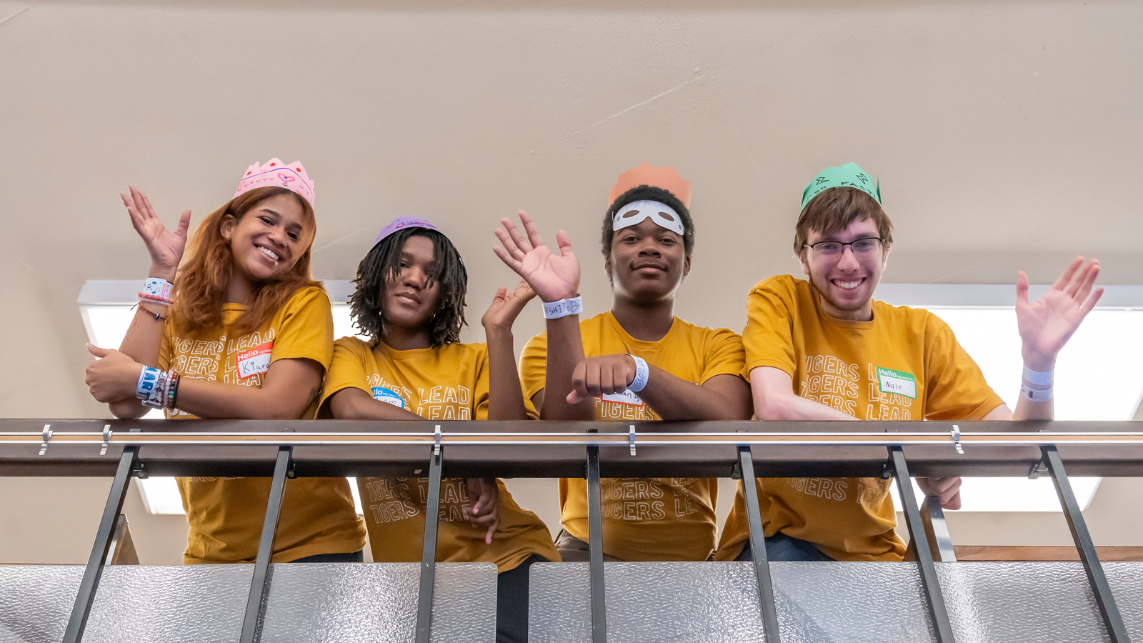 TU students in the Tigers Lead program wave to the camera during their workshop at the Towson Branch of the Baltimore County Public Library