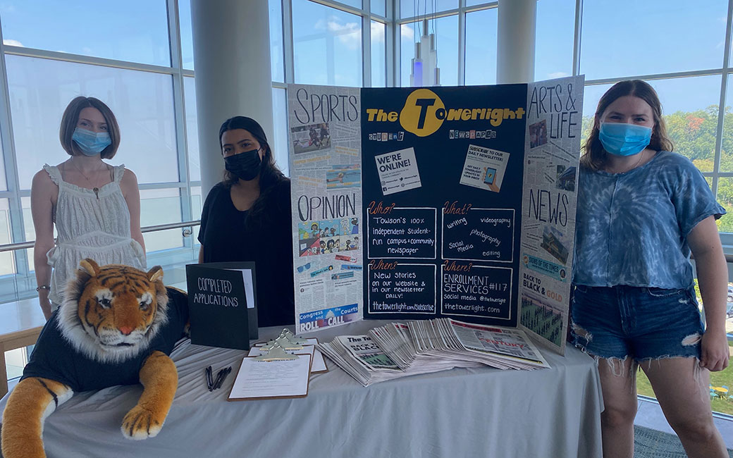 Students at table with poster