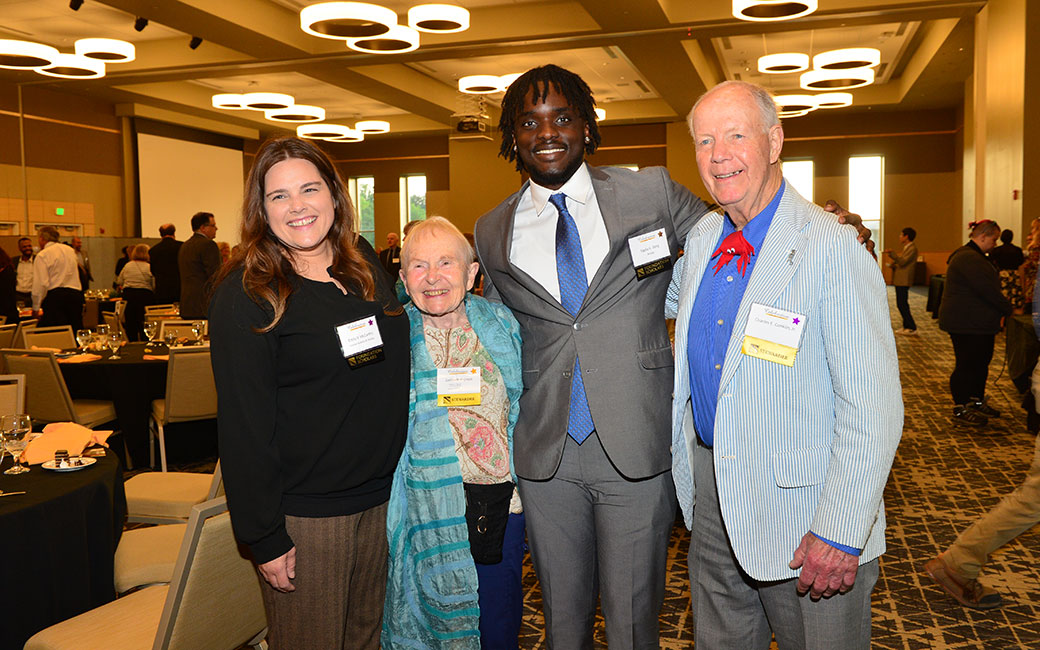 Four people posing for a picture