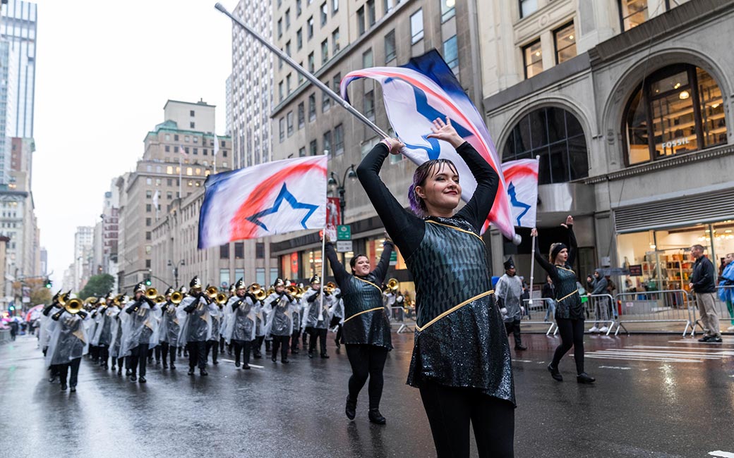 Color guard member with flag