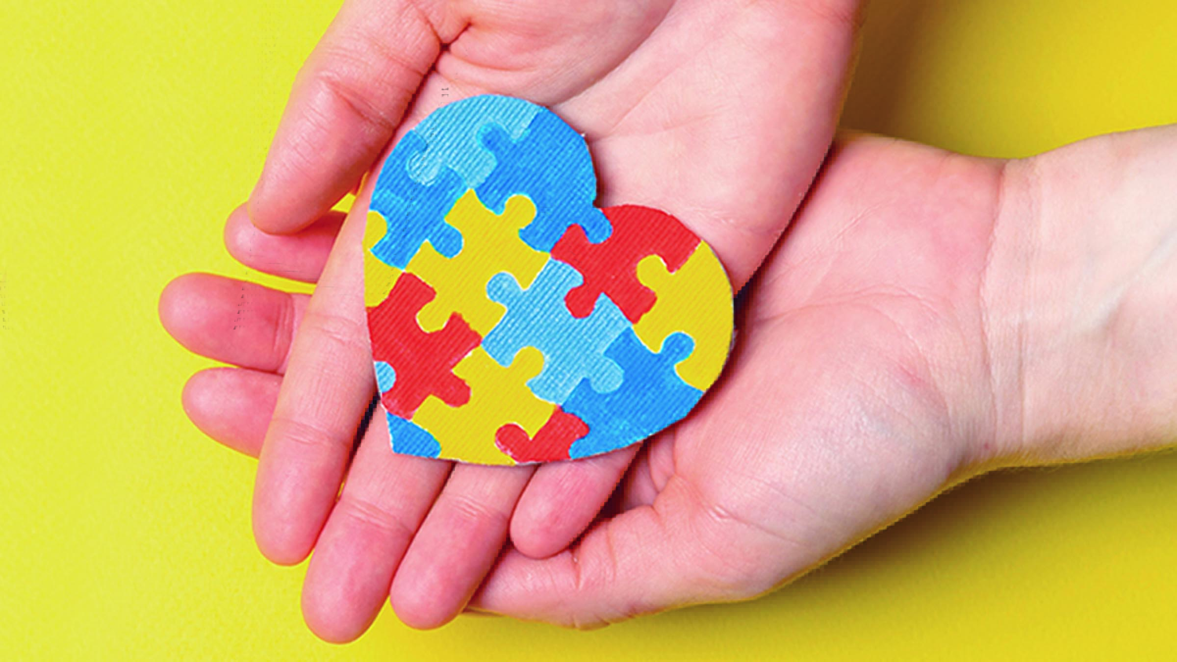 hands holding a heart puzzle