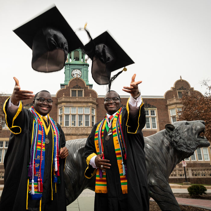 Graduates throw cap at camera