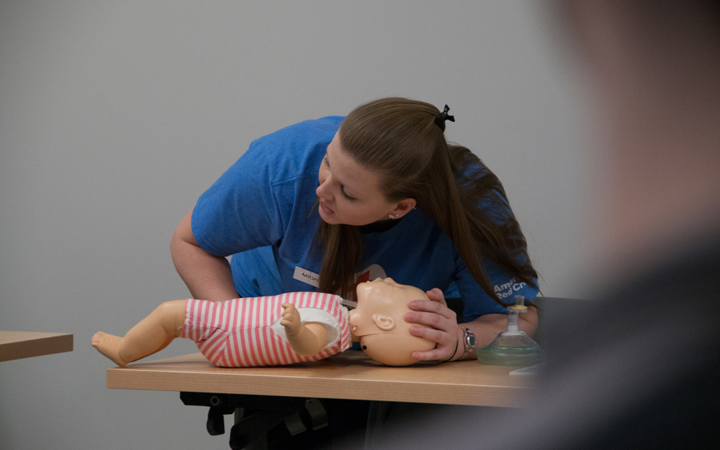 TU student providing CPR instruction