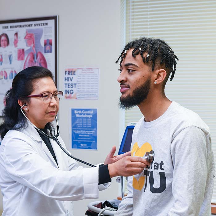 Doctor listening to a student's heartrate