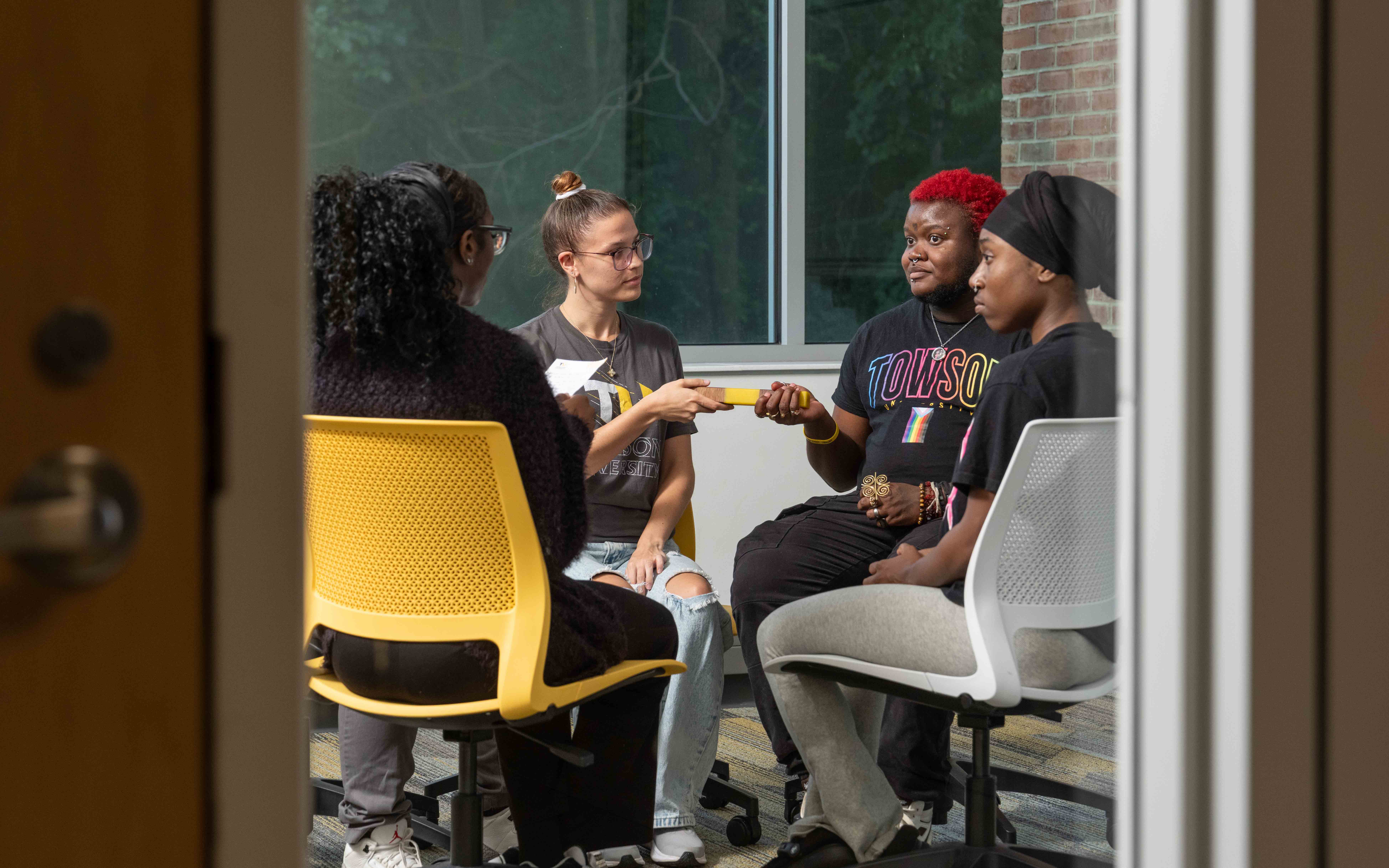 students pass around talking piece in a restorative circle